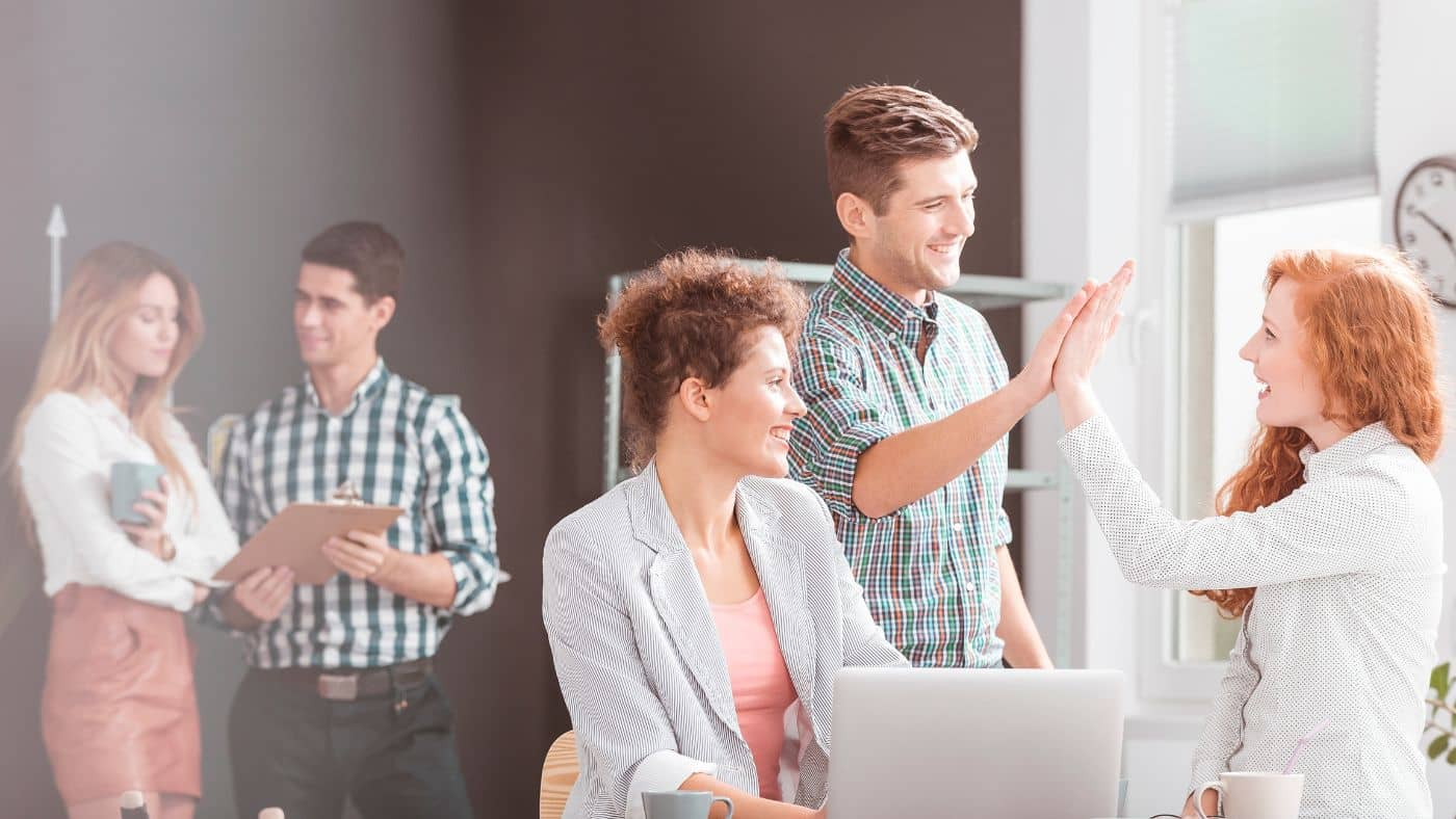 A group of people discussing how to create a positive work environment