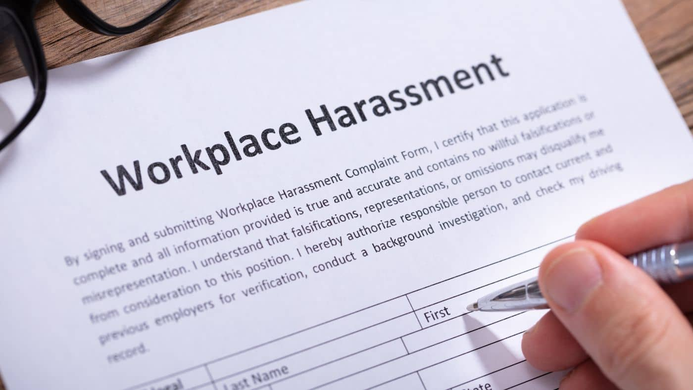 A person reporting workplace harassment to their supervisor