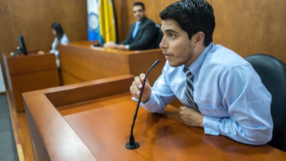 A picture of a person in a courtroom, discussing a personal injury case with a judge