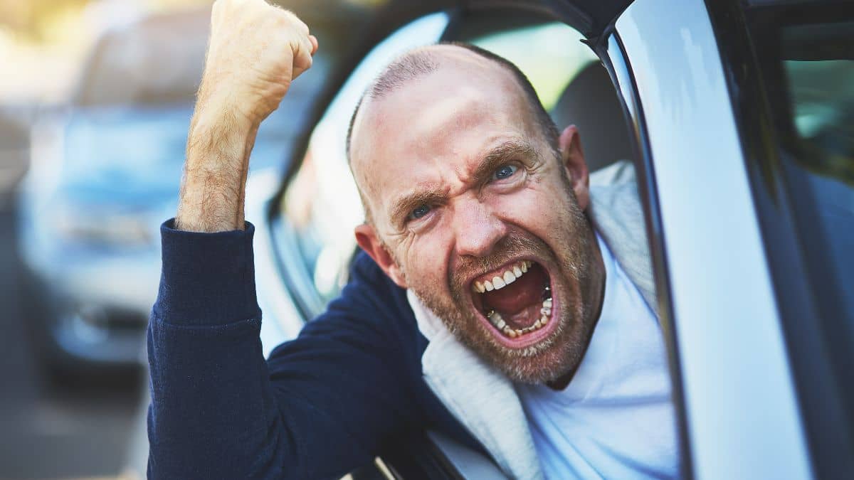 An angry driver engaging in road rage.