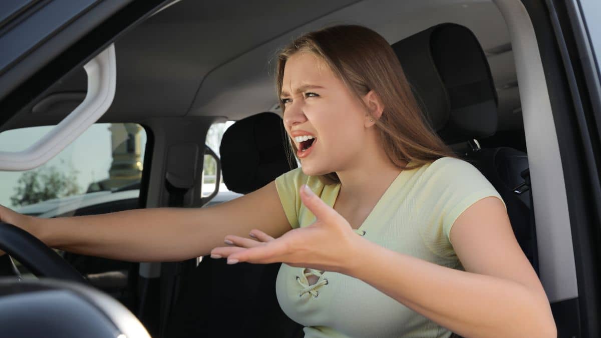A woman drives with upset after a road A woman is driving while upset after a road rage incident. incident 
